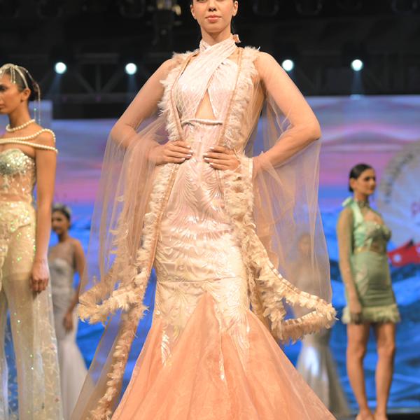 A long fleared gown with a cap shrug