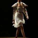 White one-piece with stylish shoulder caps and an embellished belt