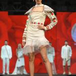 White one-piece with stylish shoulder caps and an embellished belt